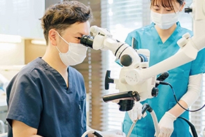 大船みらい歯科の歯科医師がマイクロスコープを使用して治療を行っている様子